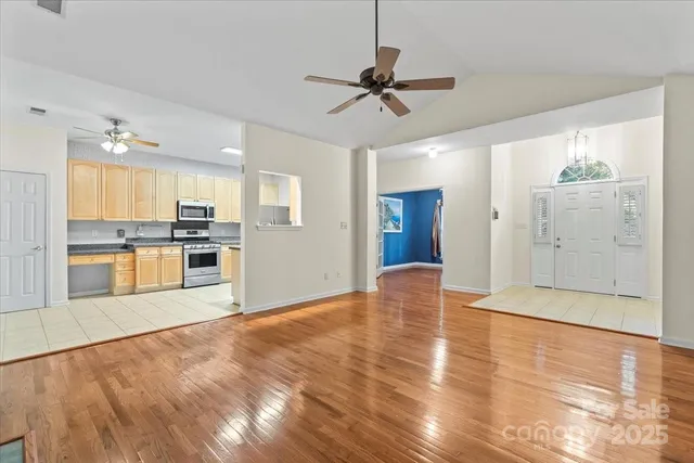 a kitchen with granite countertop a refrigerator and a stove top oven