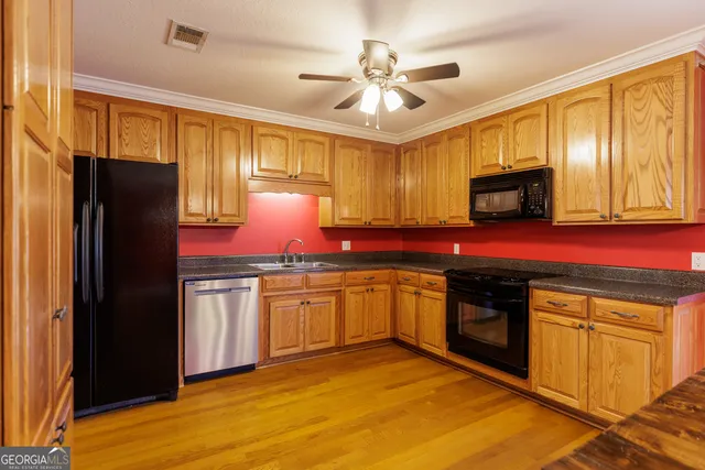 a kitchen with granite countertop cabinets stainless steel appliances and a counter space