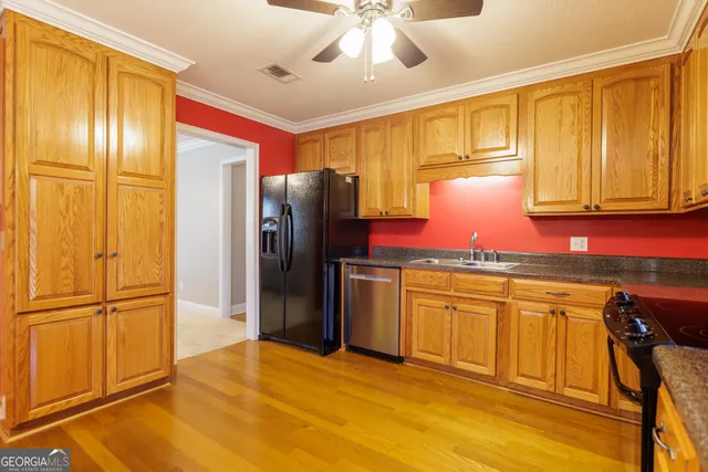 a kitchen with stainless steel appliances granite countertop a refrigerator and a stove top oven