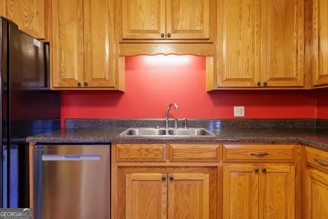 a kitchen with stainless steel appliances granite countertop a refrigerator and cabinets