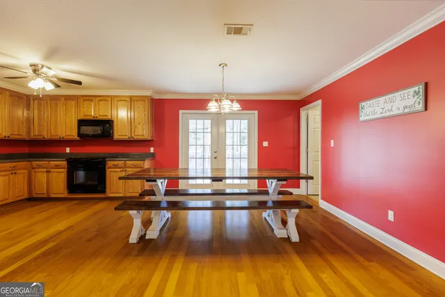 a living room with pool table and chandelier