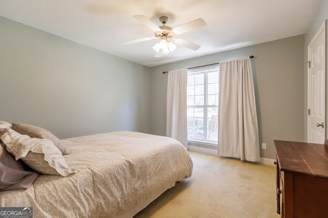 a large bed sitting in a bedroom next to a window