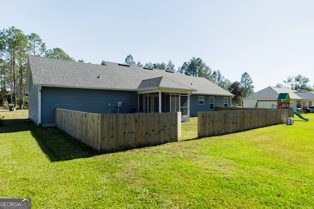 a view of a house with a yard and sitting area