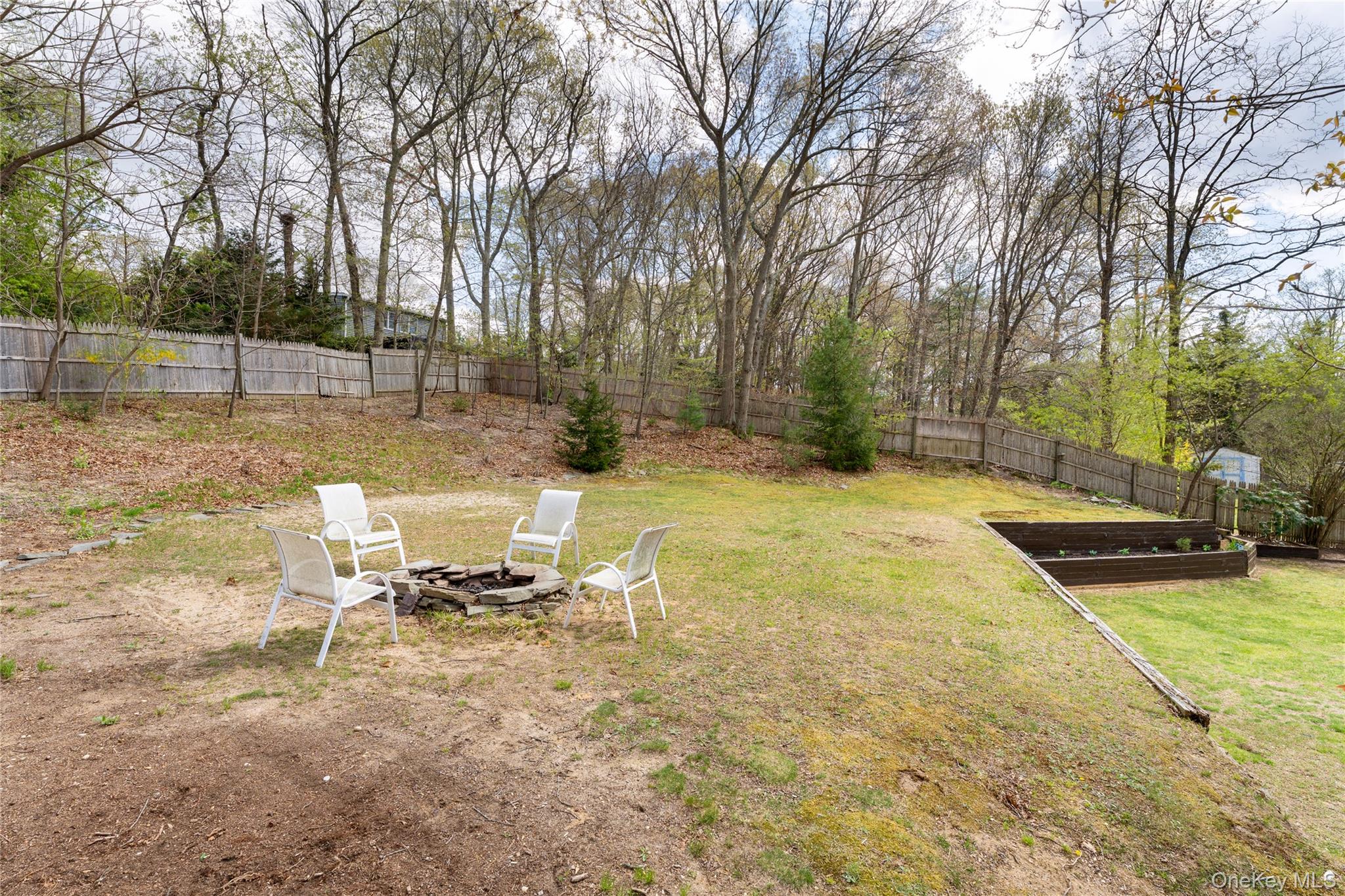 591 Meadow Road Kings Park, NY 11754 - Photo 12 of 50 a view of a backyard with a bench and trees