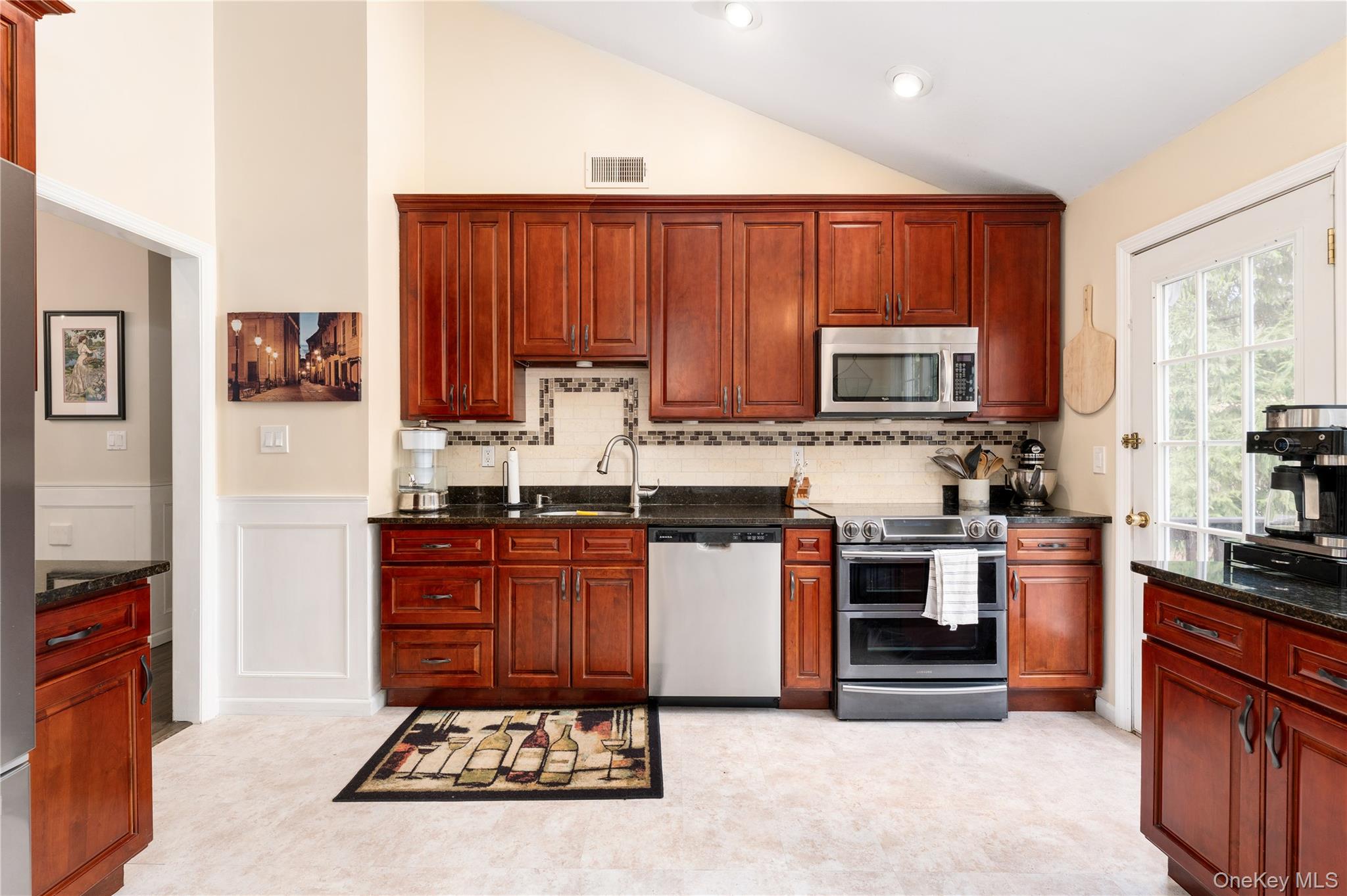 591 Meadow Road Kings Park, NY 11754 - Photo 24 of 50 a kitchen with stainless steel appliances granite countertop a stove top oven a sink and dishwasher