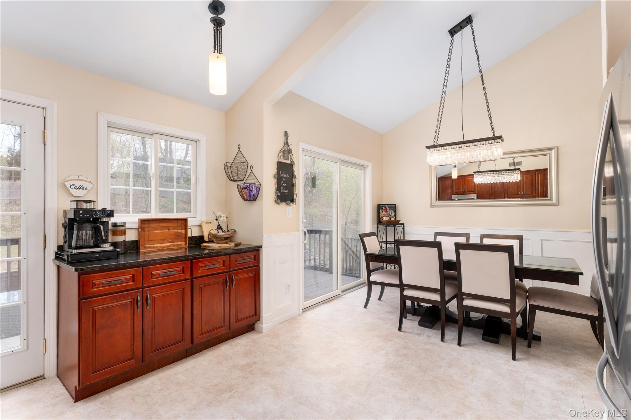 591 Meadow Road Kings Park, NY 11754 - Photo 25 of 50 a dining room with a table chairs and a kitchen view