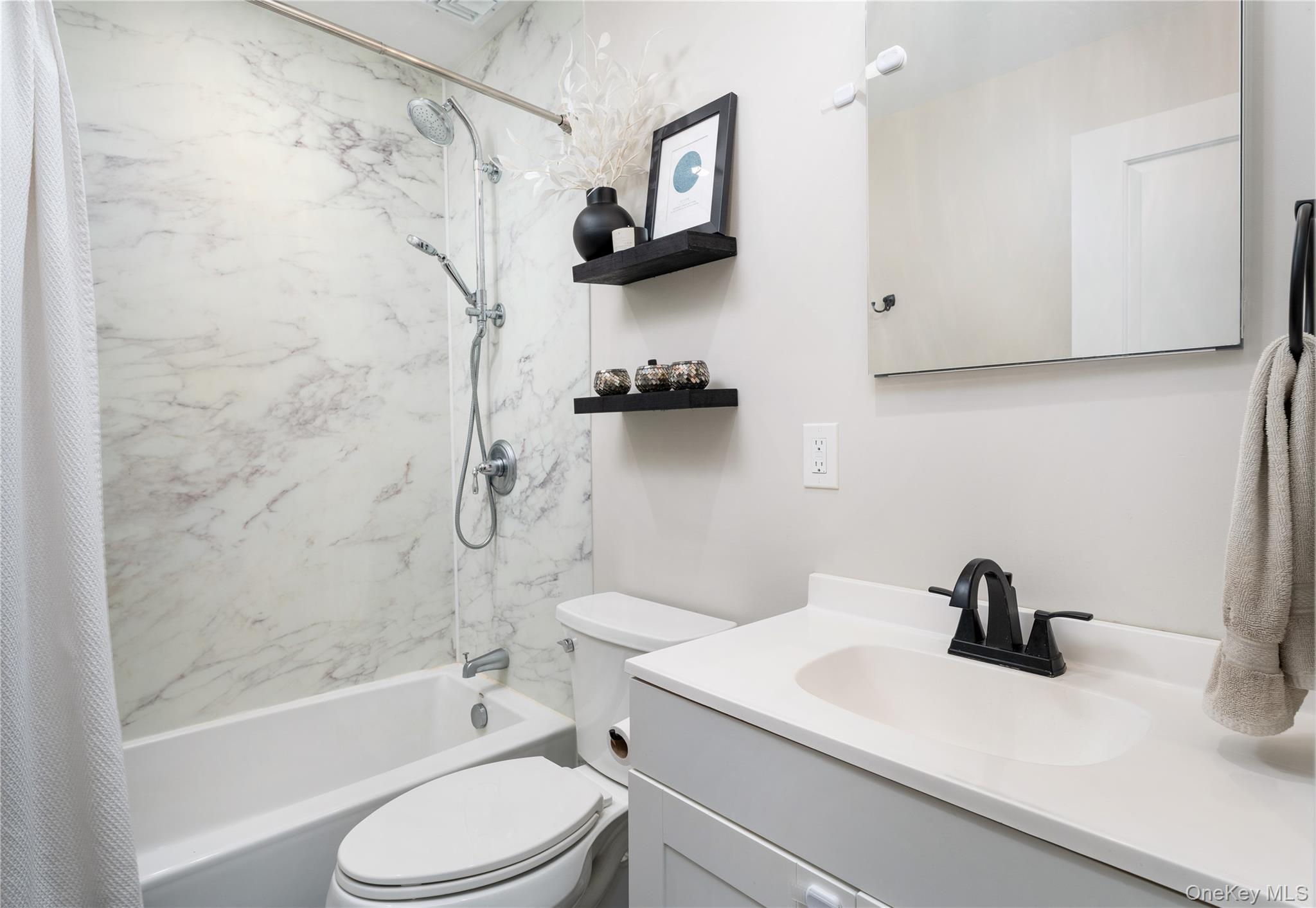 591 Meadow Road Kings Park, NY 11754 - Photo 27 of 50 a bathroom with a sink a toilet and a bathtub