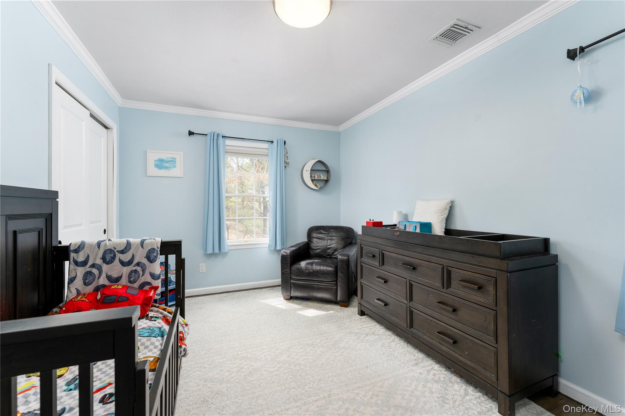 591 Meadow Road Kings Park, NY 11754 - Photo 29 of 50 a bedroom with a bed and a window