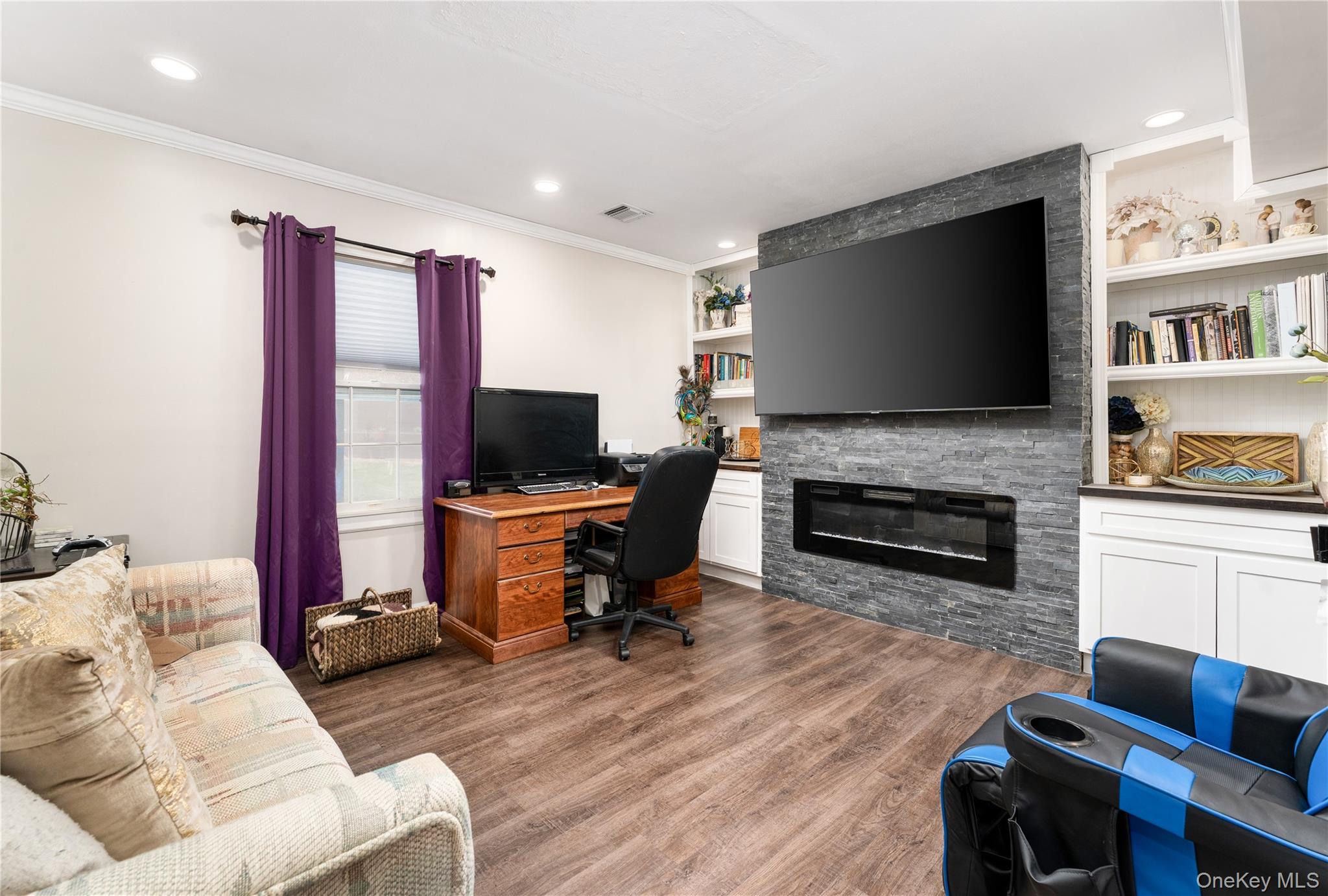 591 Meadow Road Kings Park, NY 11754 - Photo 33 of 50 a living room with furniture a flat screen tv and a fireplace
