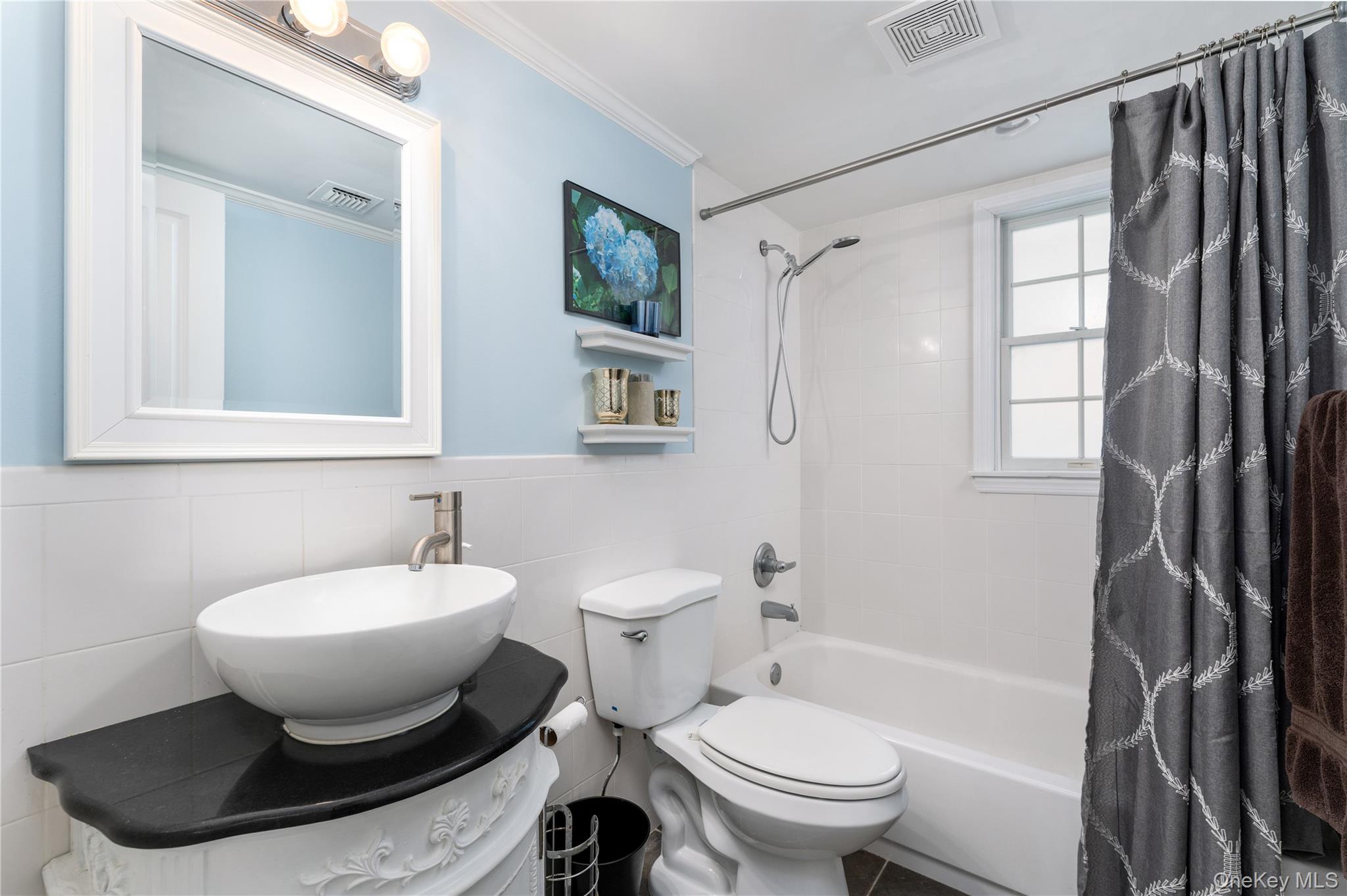 591 Meadow Road Kings Park, NY 11754 - Photo 35 of 50 a bathroom with a toilet sink and shower