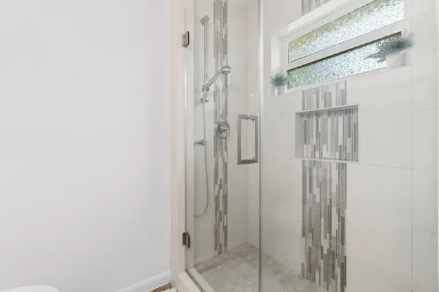 a bathroom with a glass shower door