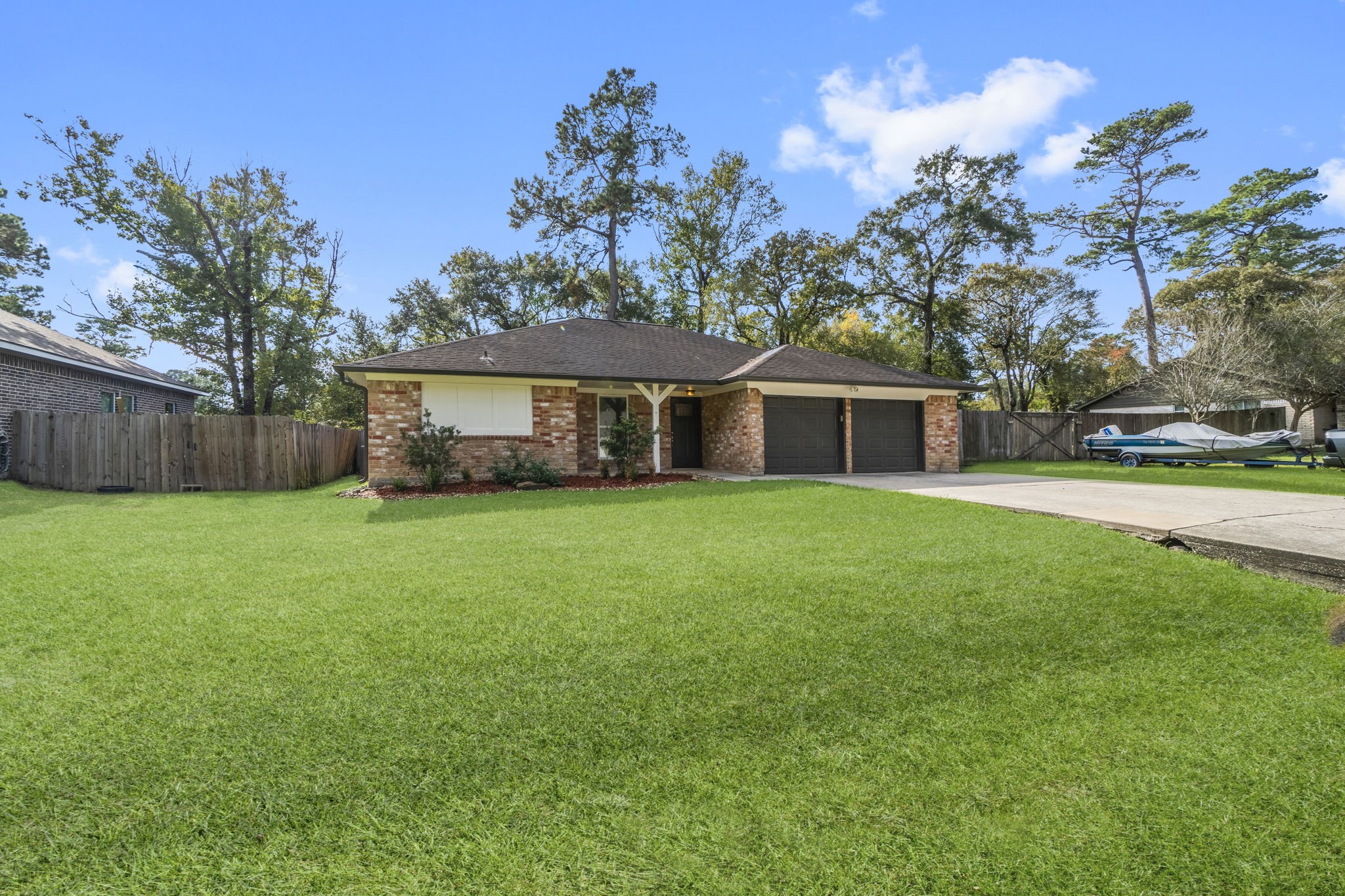3223 Kentwood Drive Spring, TX 77380 - Photo 2 of 31 Additional angle of the front elevation highlighting the extended driveway and spacious front yard.