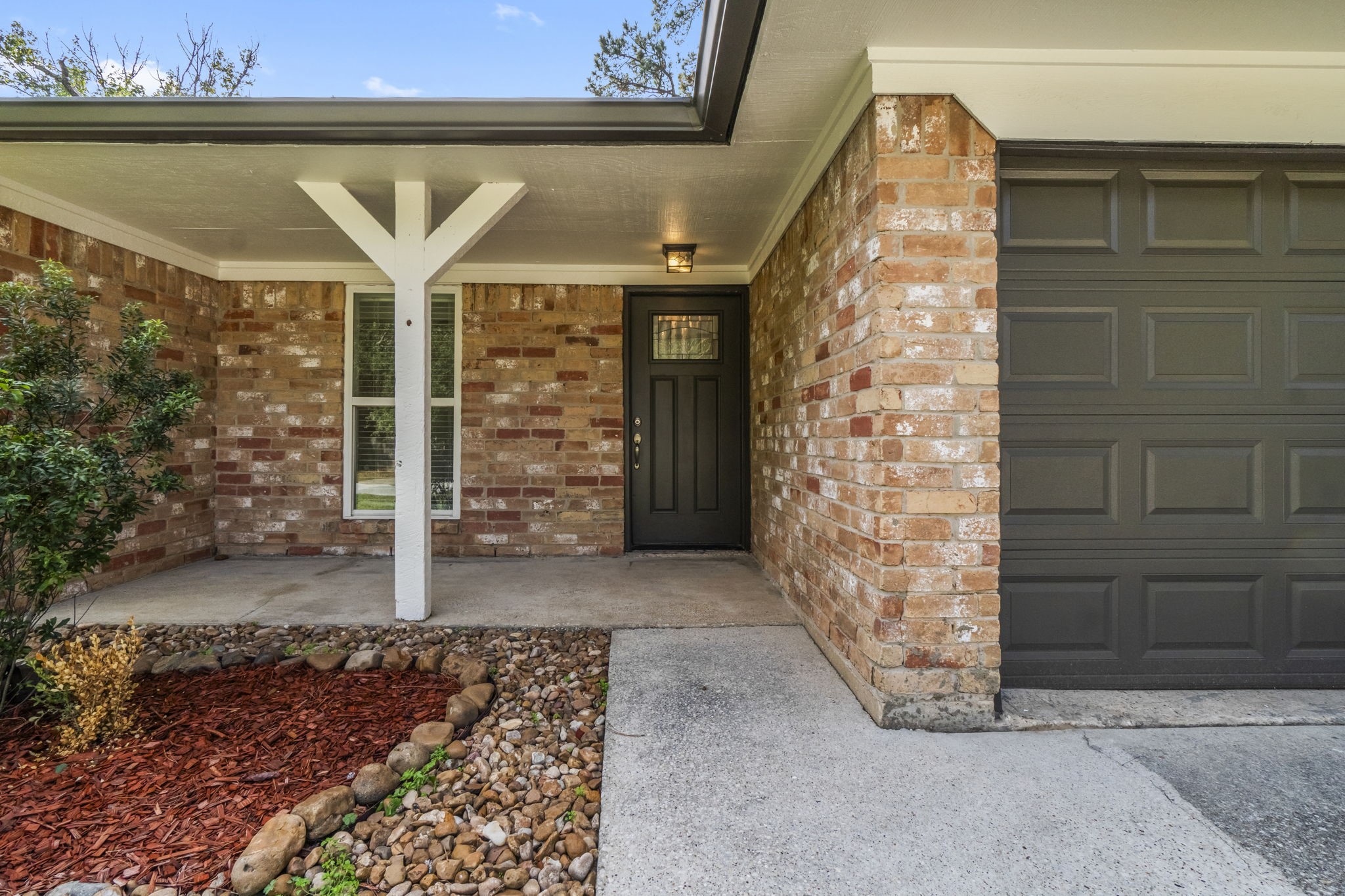 3223 Kentwood Drive Spring, TX 77380 - Photo 3 of 31 Covered front porch with brick accents and a sheltered walkway creating a warm and inviting entrance.