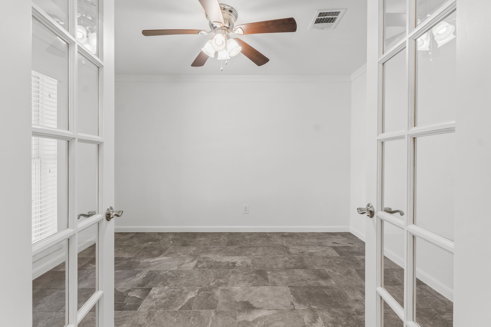 3223 Kentwood Drive Spring, TX 77380 - Photo 5 of 31 Versatile front room with double French doors, ceiling fan, and abundant natural light - ideal for an office, study, or additional sitting room.