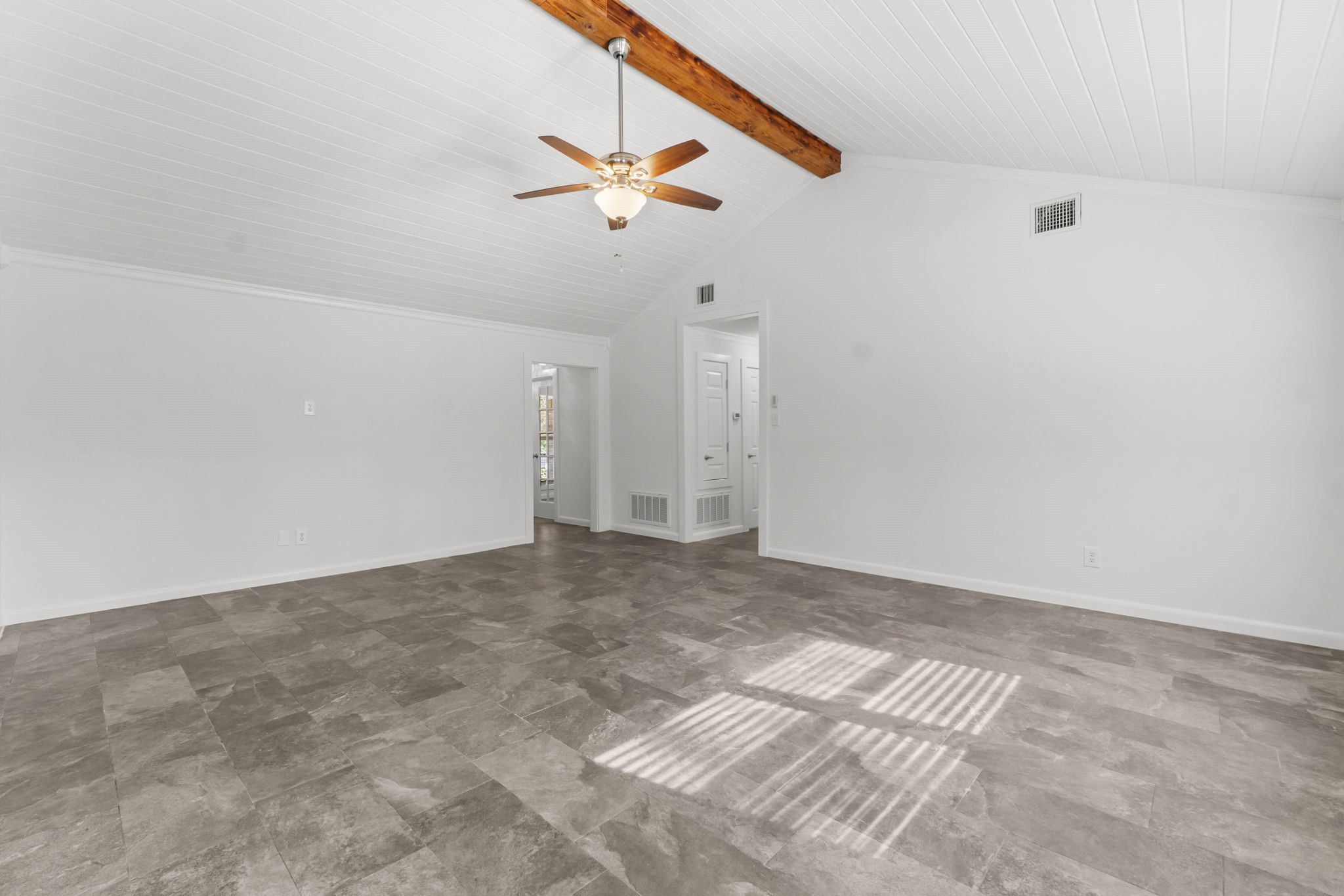 3223 Kentwood Drive Spring, TX 77380 - Photo 9 of 31 This spacious living room features ample floor area for multiple furniture arrangements and transitions seamlessly into the adjoining dining and kitchen spaces. Clean lines, fresh finishes, and warm natural light make it an ideal central gathering spot.