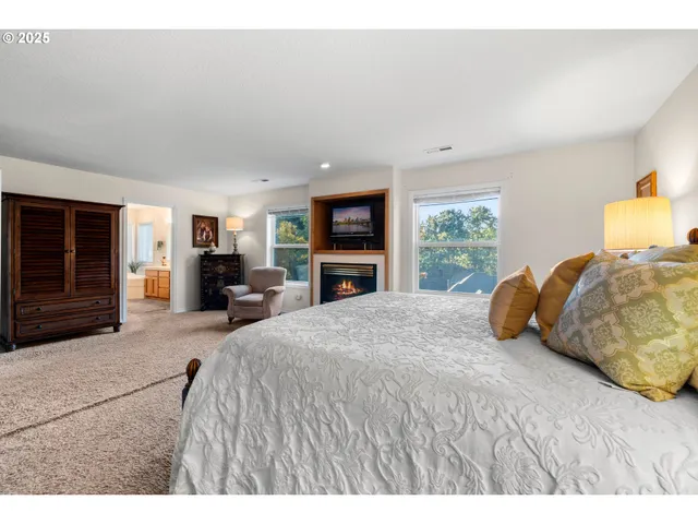 a bedroom with a large bed and a tv