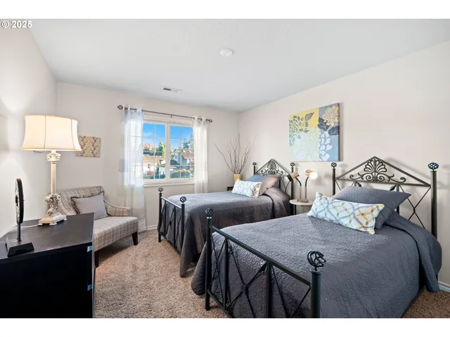 a bedroom with two beds and a window