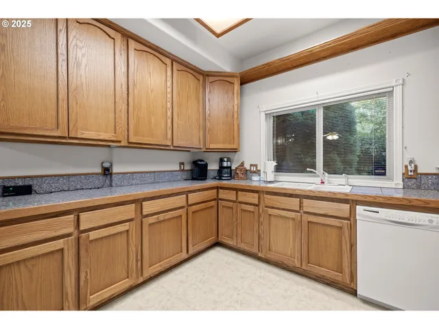 a kitchen with stainless steel appliances granite countertop a sink and cabinets