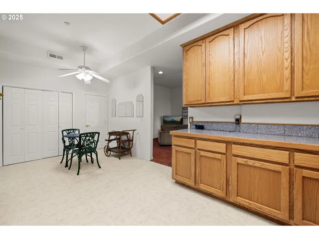 a kitchen with sink and white cabinets