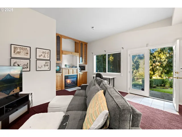a living room with furniture large window and flat screen tv