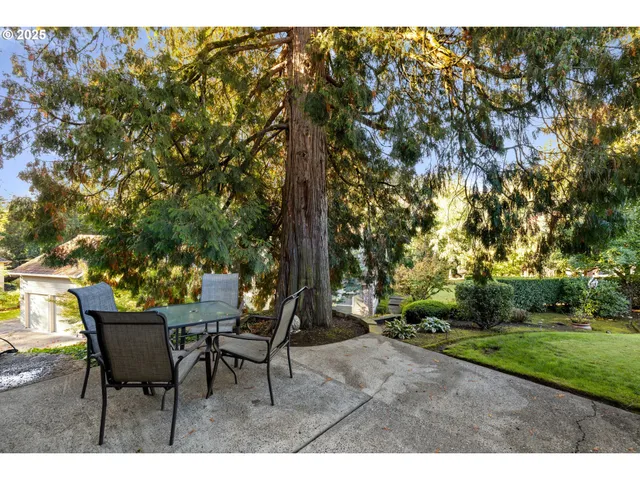 a backyard of a house with table and chairs