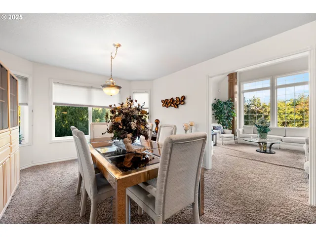 a dining room with furniture window and outside view