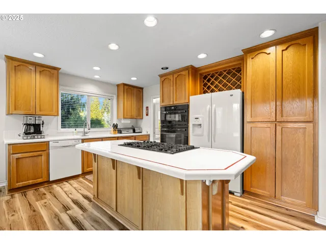 a kitchen with a sink a refrigerator and a stove