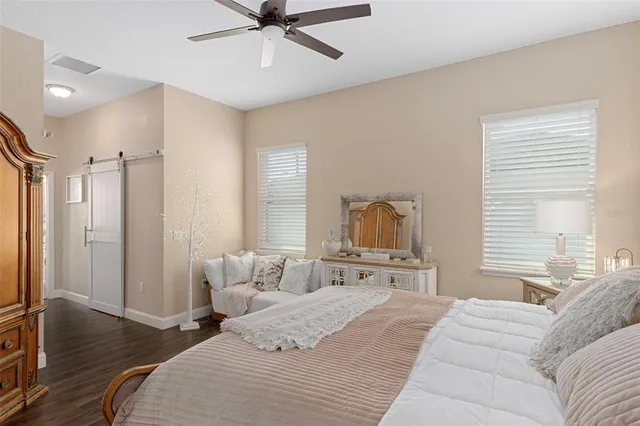 a bedroom with a bed and a chandelier