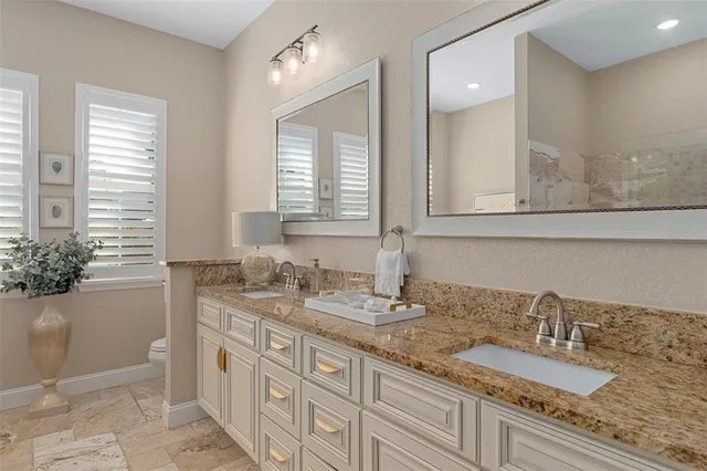 a bathroom with double sink and a mirror