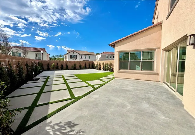 a view of swimming pool with a yard and potted plants