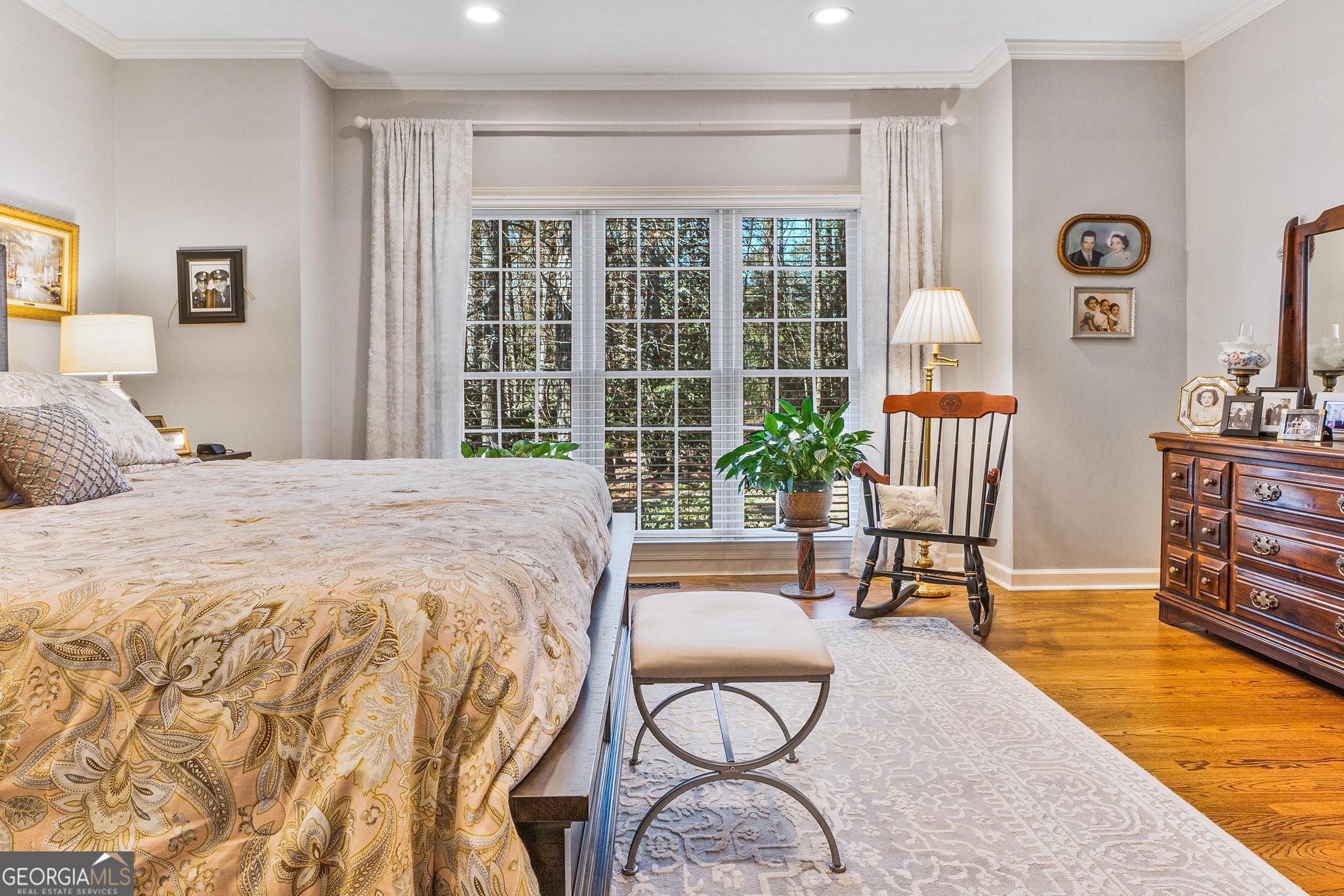 204 Carriage Way Macon, GA 31210 - Photo 14 of 28 a spacious bedroom with a bed a table and chair with the floor