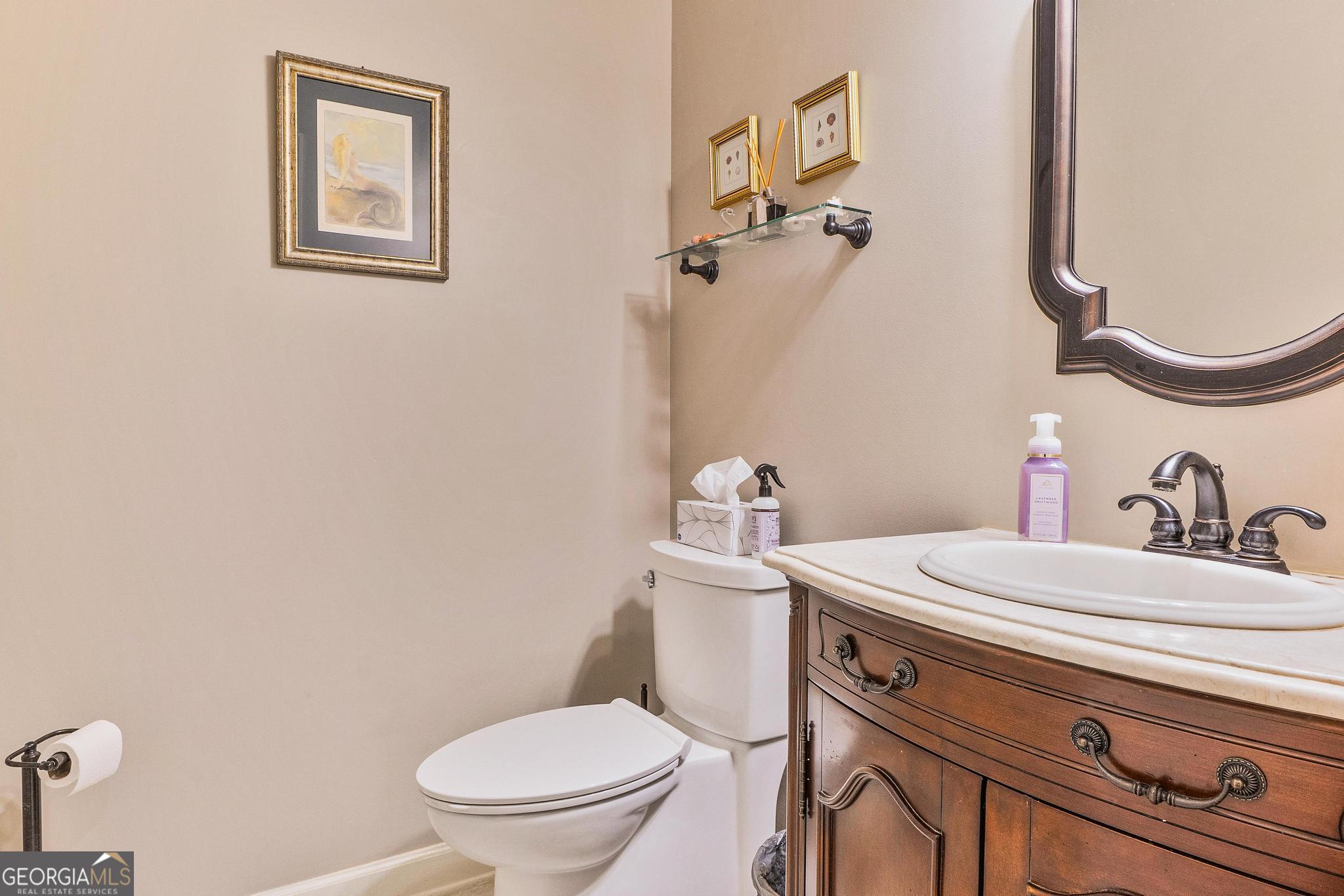 204 Carriage Way Macon, GA 31210 - Photo 16 of 28 a bathroom with a toilet sink and mirror