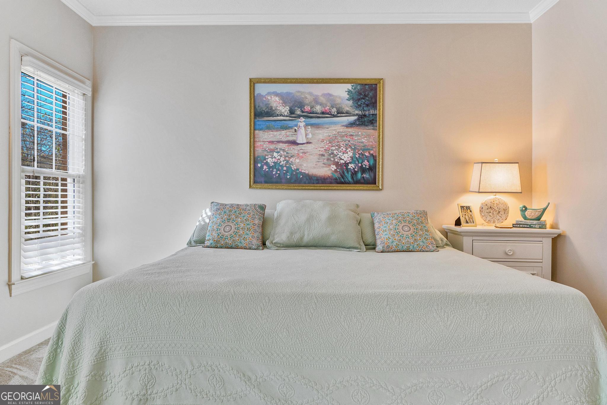 204 Carriage Way Macon, GA 31210 - Photo 23 of 28 a bedroom with a bed and a painting on the wall