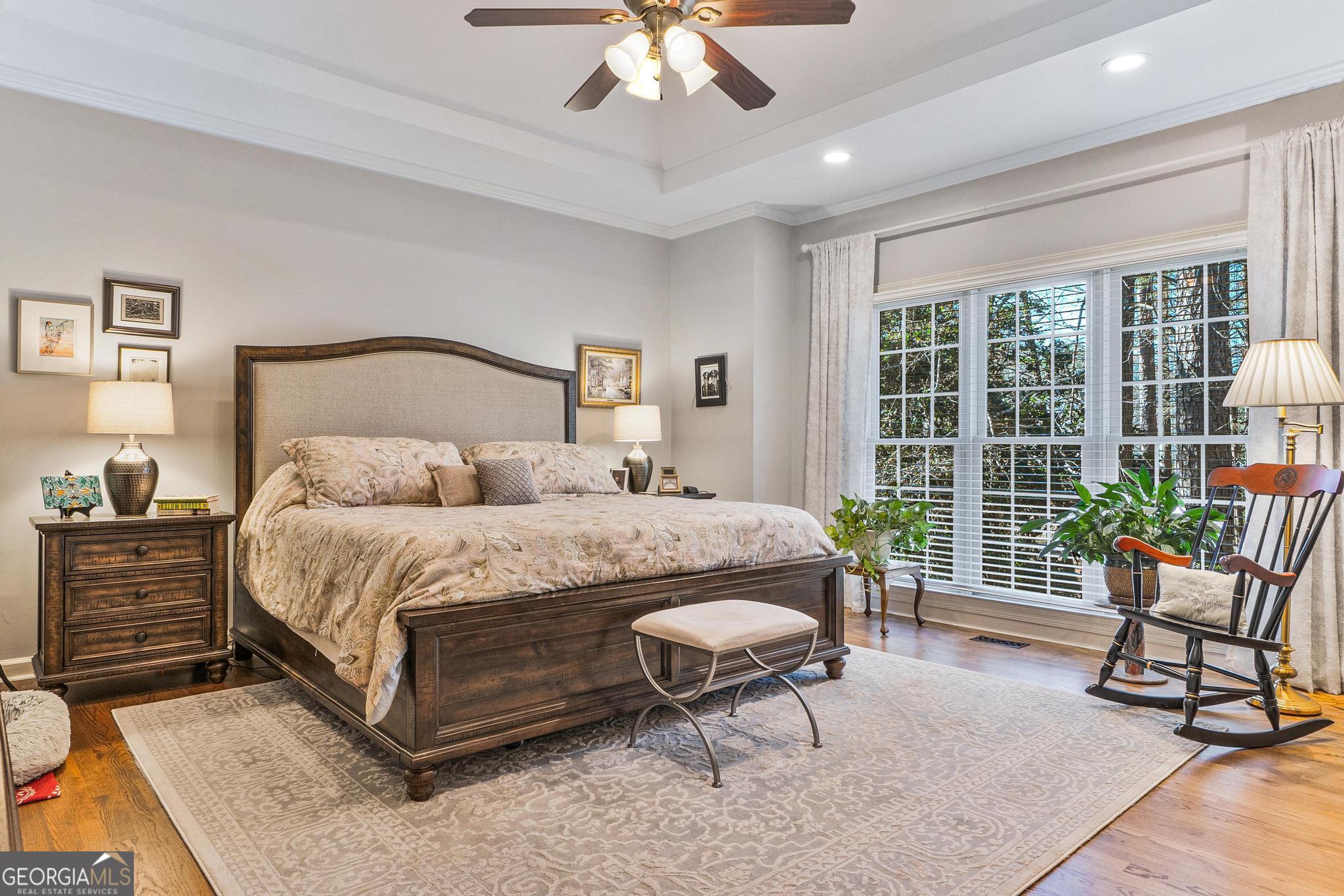 204 Carriage Way Macon, GA 31210 - Photo 25 of 28 a bedroom with a bed a chair and a large window