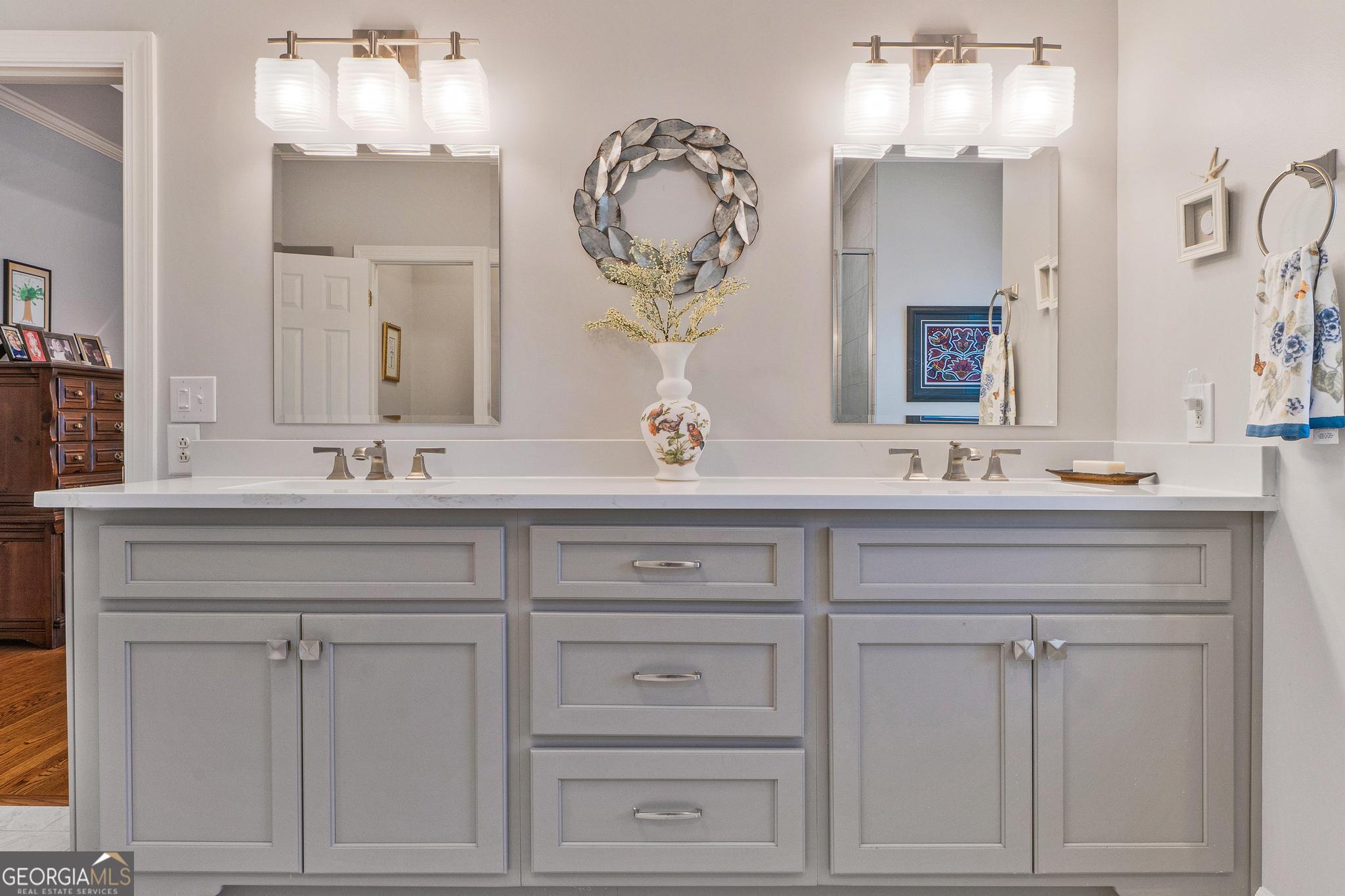 204 Carriage Way Macon, GA 31210 - Photo 28 of 28 a bathroom with white cabinets a sink and a mirror