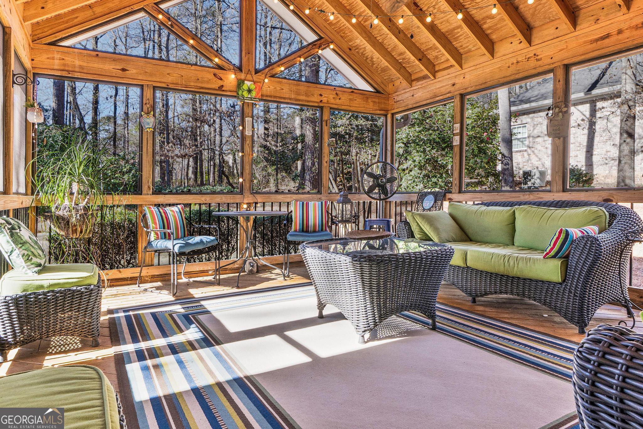 204 Carriage Way Macon, GA 31210 - Photo 5 of 28 a view of a patio with couches chairs and wooden floor