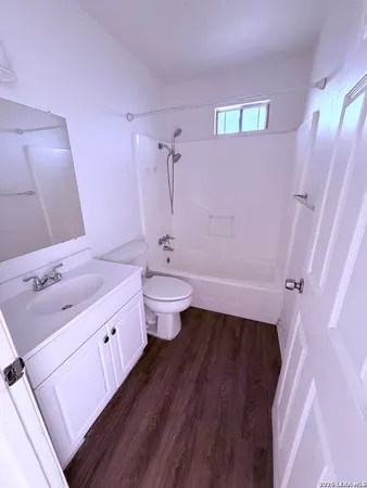 a bathroom with a bathtub sink mirror and toilet