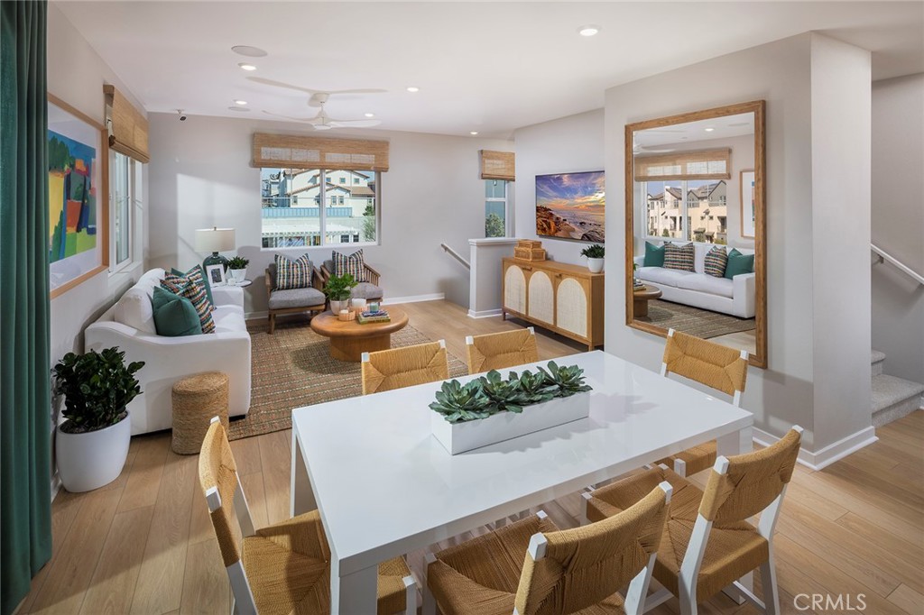 6059 Burren Way Eastvale, CA 92880 - Photo 3 of 30 a living room with furniture dining table and wooden floor