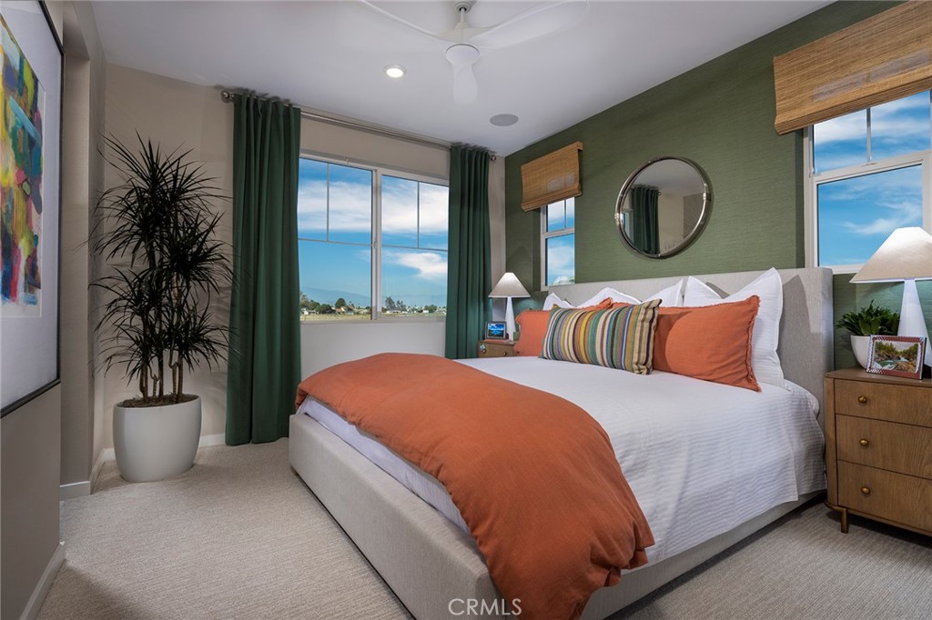 6059 Burren Way Eastvale, CA 92880 - Photo 4 of 30 a bedroom with a large bed and a potted plant