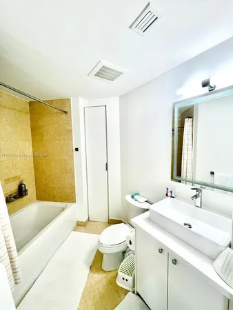 a bathroom with a double vanity sink and mirror