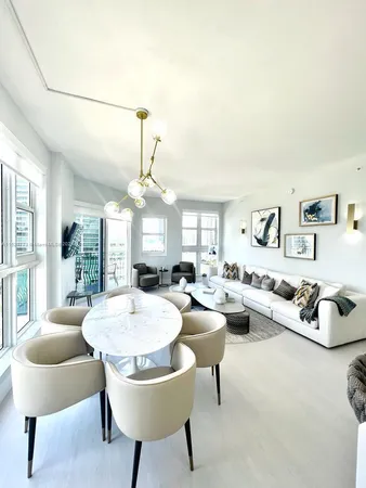 a living room with furniture and a chandelier