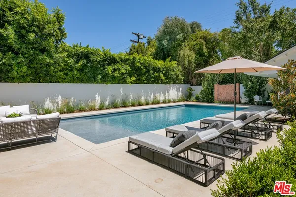 an outdoor sitting area with furniture