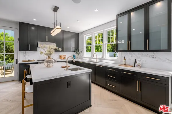 a kitchen with a sink stove and cabinets