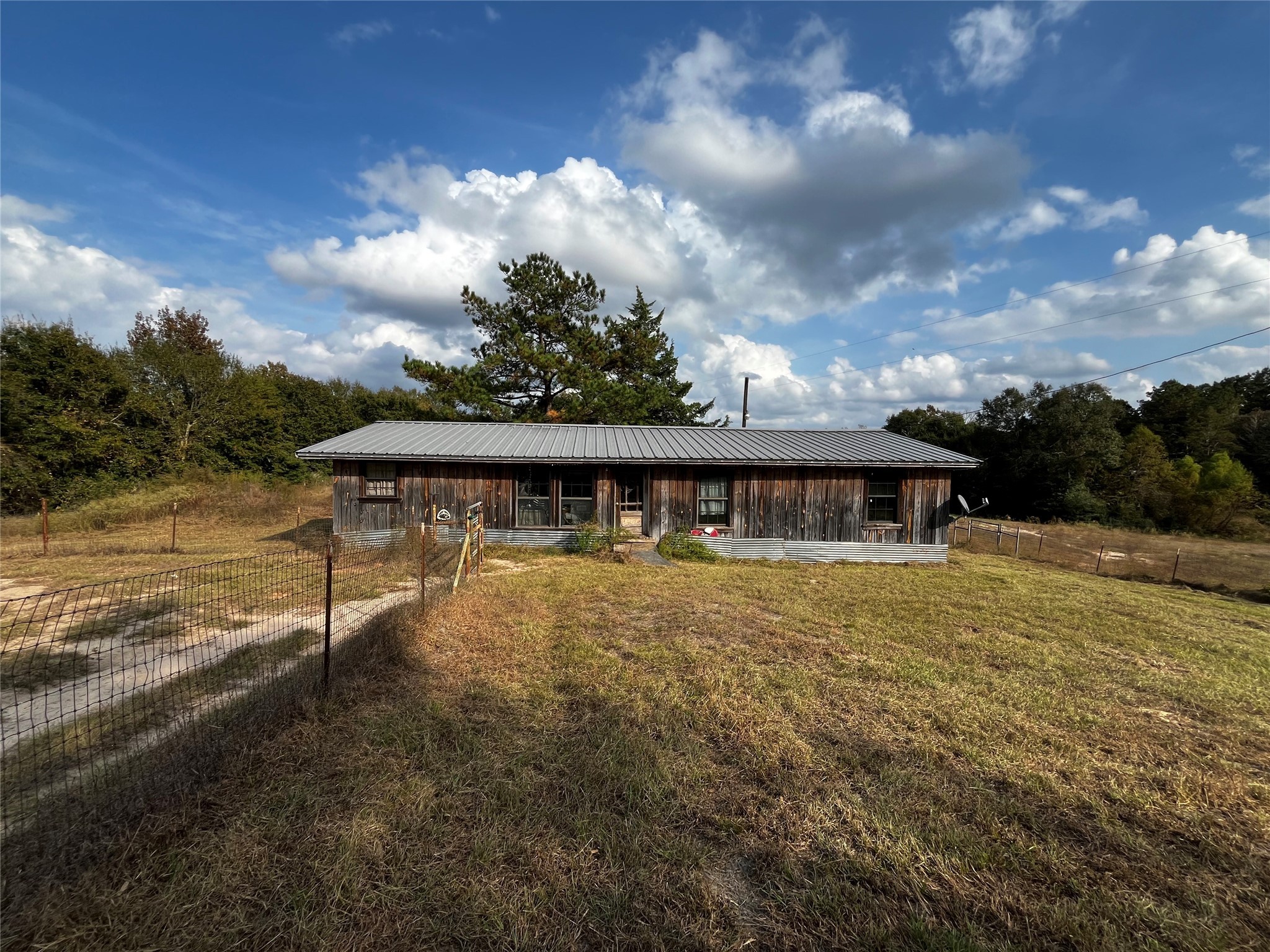 231 County Road 2190 Cleveland, TX 77327 - Photo 34 of 35 a backyard of a house with table and chairs