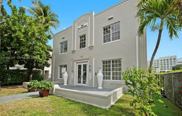 a view of house with backyard and garden
