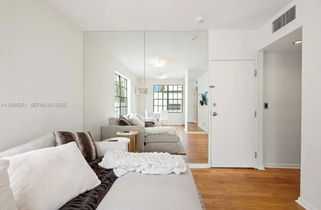a bedroom with furniture and a large window