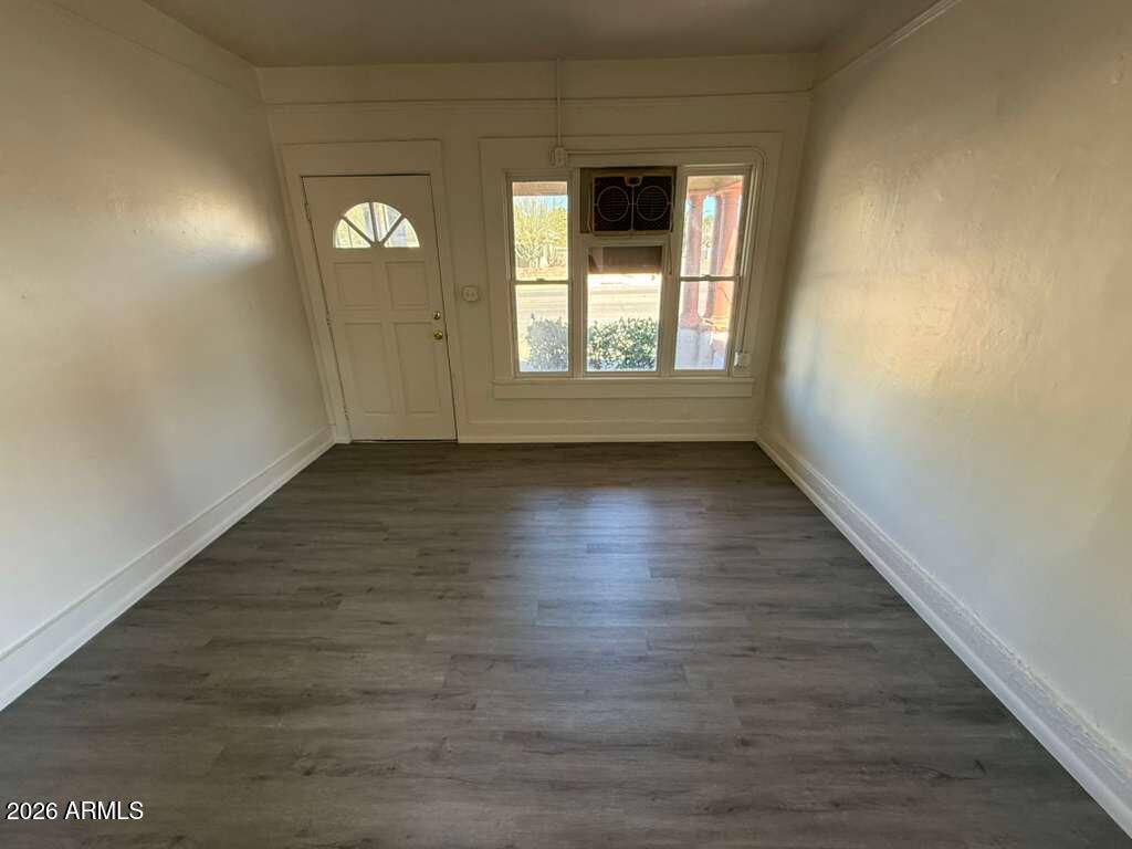 663 East 8th Street Douglas, AZ 85607 - Photo 3 of 11 a view of an empty room with wooden floor and a window