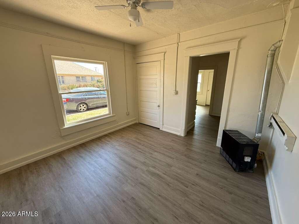 663 East 8th Street Douglas, AZ 85607 - Photo 4 of 11 an empty room with wooden floor and windows