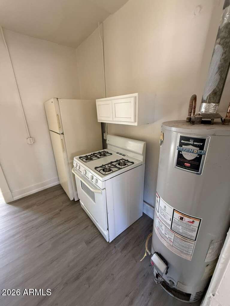 663 East 8th Street Douglas, AZ 85607 - Photo 6 of 11 a white kitchen with sink stove and refrigerator