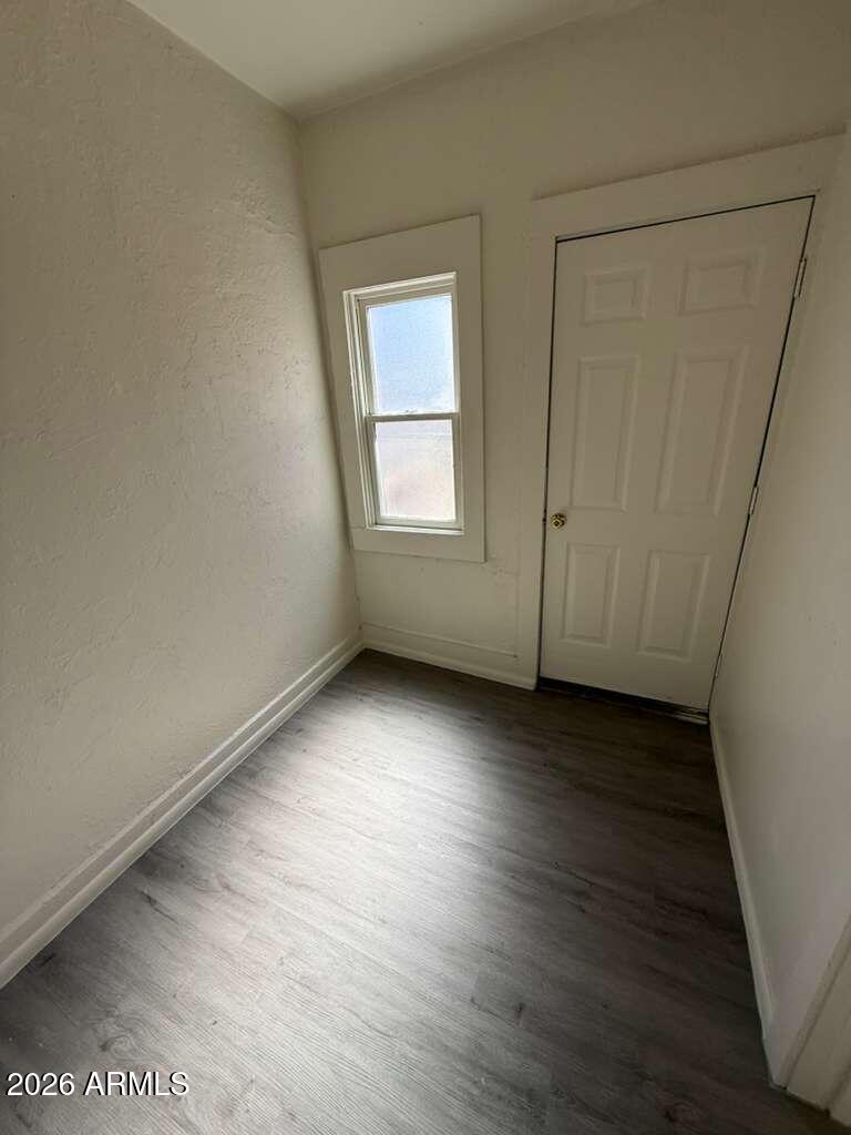 663 East 8th Street Douglas, AZ 85607 - Photo 8 of 11 an empty room with wooden floor and windows